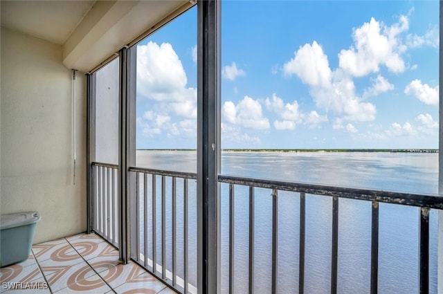 unfurnished sunroom with a water view