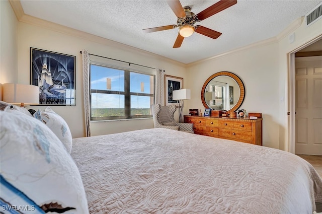 bedroom featuring ceiling fan, a textured ceiling, and crown molding