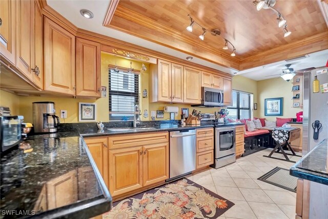 kitchen featuring sink, light tile patterned floors, a tray ceiling, wood ceiling, and stainless steel appliances