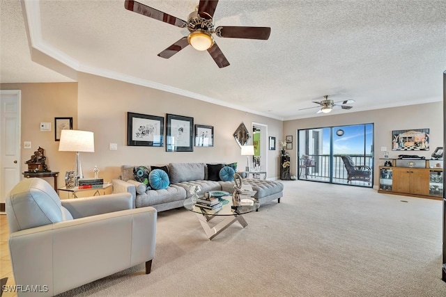 living room featuring light carpet, a textured ceiling, ceiling fan, and ornamental molding