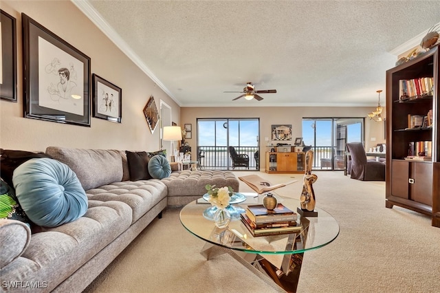 living room featuring ceiling fan with notable chandelier, carpet, ornamental molding, and a textured ceiling