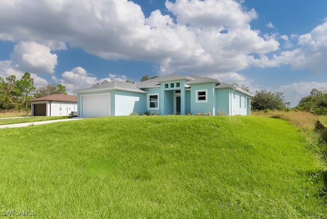 view of front of home with a garage and a front yard