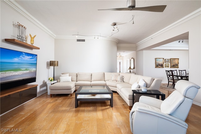 living room with hardwood / wood-style flooring, ceiling fan, and ornamental molding