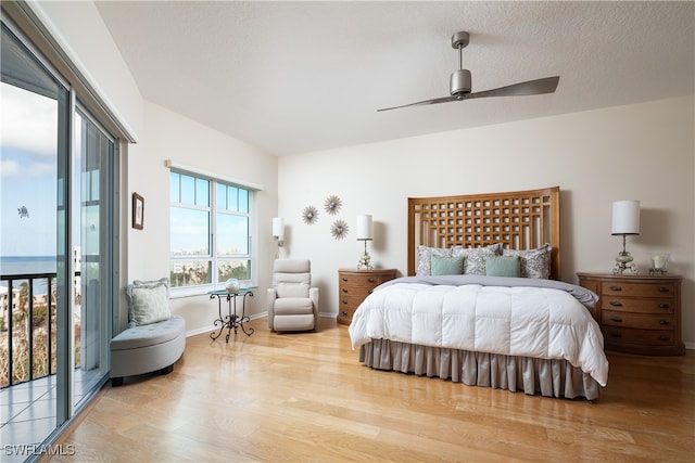 bedroom featuring access to exterior, ceiling fan, and light wood-type flooring