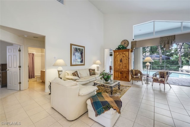 tiled living room featuring a high ceiling