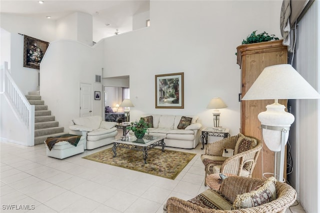 tiled living room with a towering ceiling