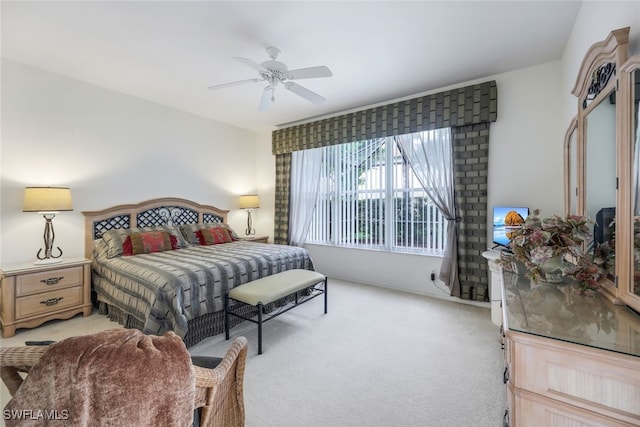 bedroom with ceiling fan and light carpet