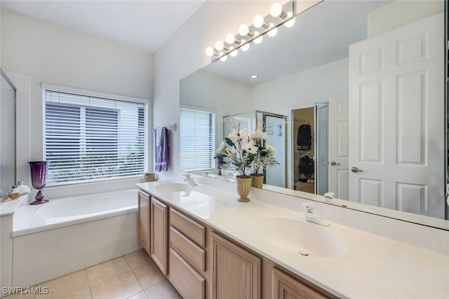 bathroom featuring tile patterned flooring, shower with separate bathtub, and vanity