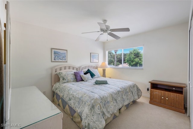 bedroom featuring light carpet and ceiling fan