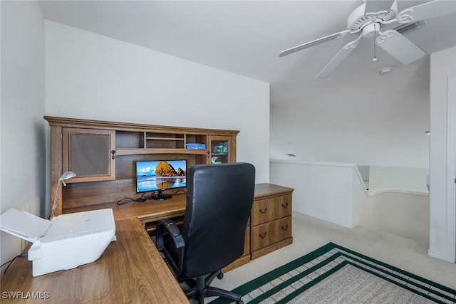 office space featuring light carpet and ceiling fan