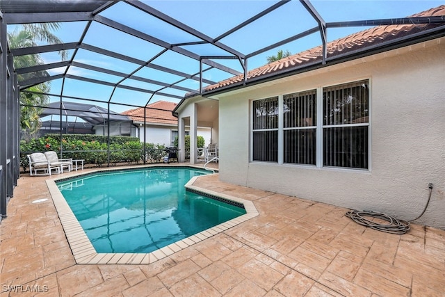 view of pool featuring a patio and glass enclosure