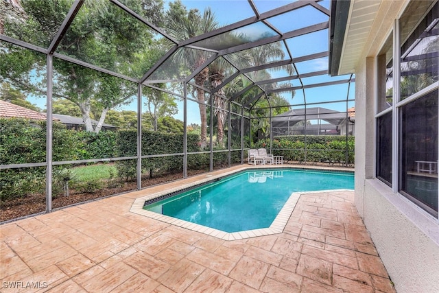 view of pool featuring a lanai and a patio