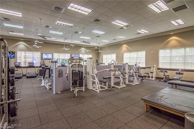 exercise room featuring a wealth of natural light, a paneled ceiling, and ceiling fan