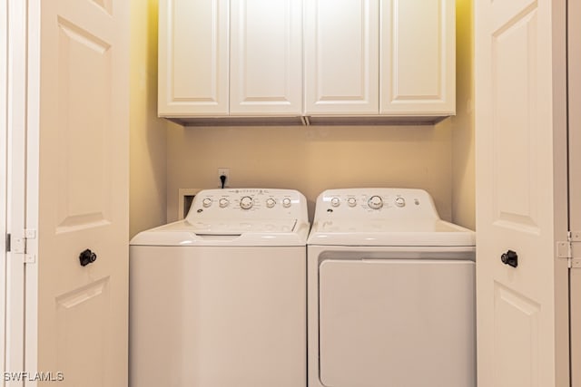 laundry area featuring cabinets and independent washer and dryer