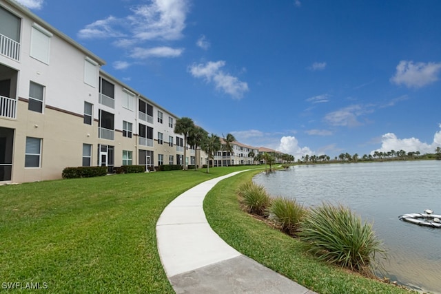 view of property's community featuring a water view and a yard