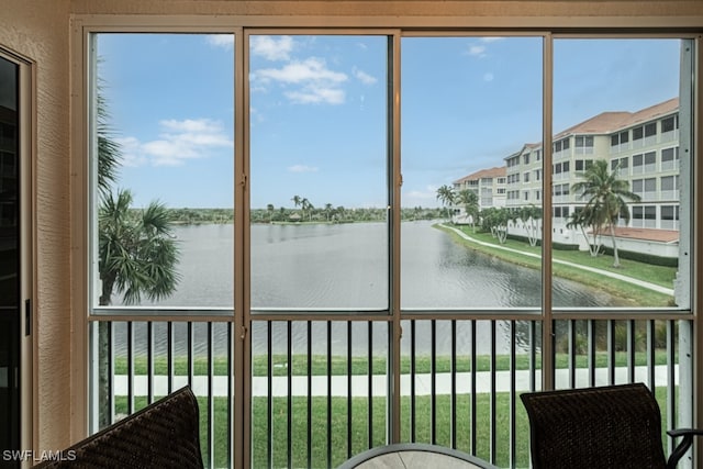 unfurnished sunroom featuring a water view