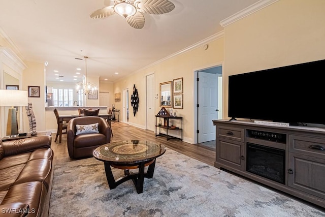 17100 Bridgestone Ct Unit 205, Fort Myers, FL 33908 - living room with ornamental molding, a ceiling fan, wood finished floors, a chandelier, and baseboards