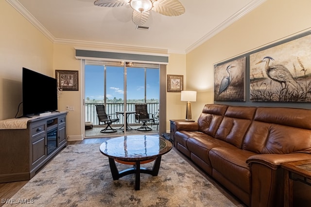 living room featuring hardwood / wood-style flooring, crown molding, and ceiling fan