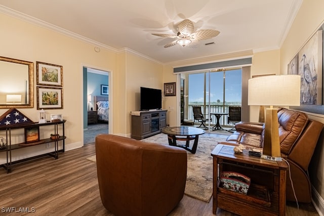 living room with ornamental molding, hardwood / wood-style flooring, and ceiling fan