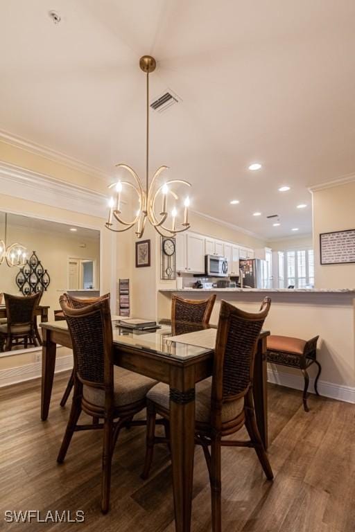 17100 Bridgestone Ct Unit 205, Fort Myers, FL 33908 - dining area with a chandelier, crown molding, dark wood-type flooring, baseboards, and recessed lighting