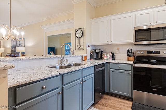 kitchen with stainless steel appliances, white cabinetry, sink, and crown molding