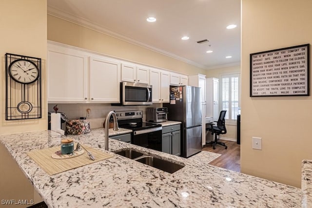 17100 Bridgestone Ct Unit 205, Fort Myers, FL 33908 - kitchen featuring appliances with stainless steel finishes, ornamental molding, white cabinets, light stone countertops, and tasteful backsplash