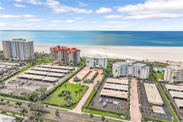 bird's eye view featuring a water view and a view of the beach