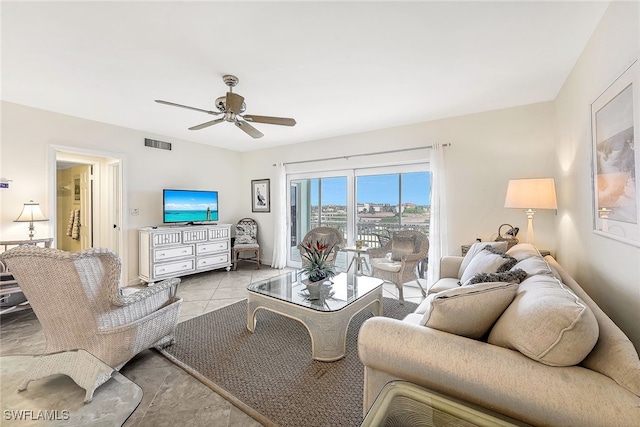 tiled living room featuring ceiling fan