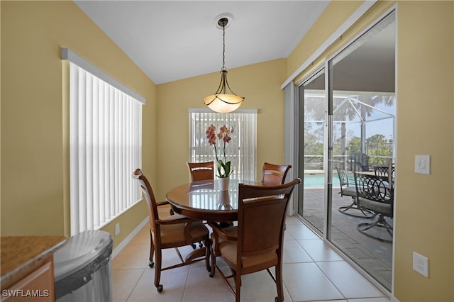 tiled dining space with vaulted ceiling