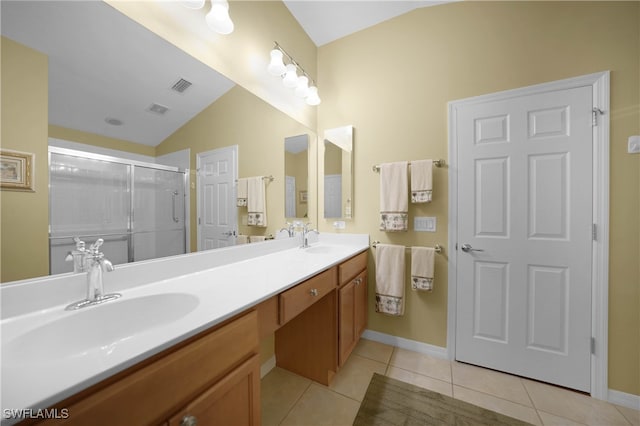 bathroom with walk in shower, vanity, lofted ceiling, and tile patterned flooring