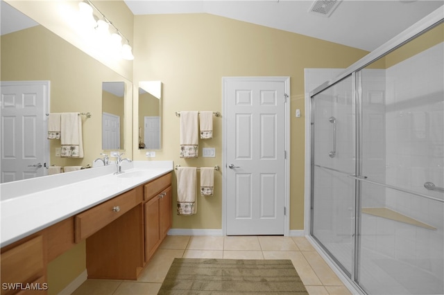 bathroom featuring a shower with door, vanity, tile patterned floors, and vaulted ceiling