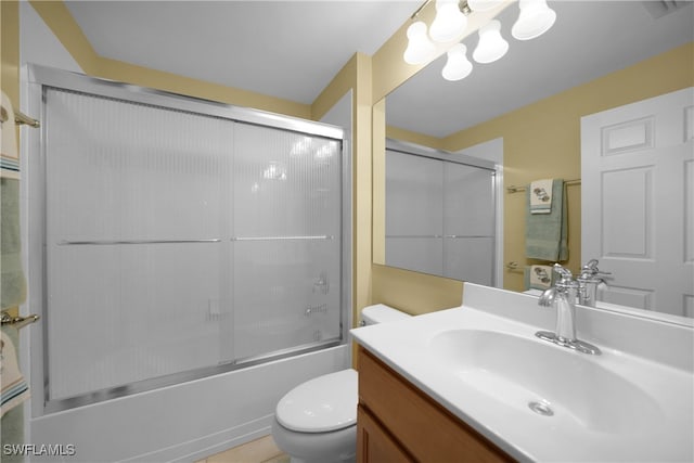 full bathroom featuring tile patterned flooring, shower / bath combination with glass door, toilet, and vanity