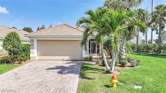 view of front of house with a garage and a front yard