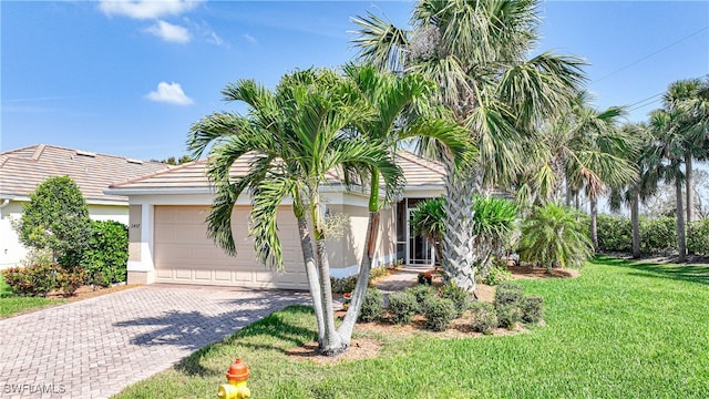 view of front of property with a front lawn and a garage