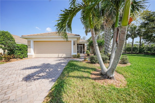 view of front of home featuring a garage and a front lawn