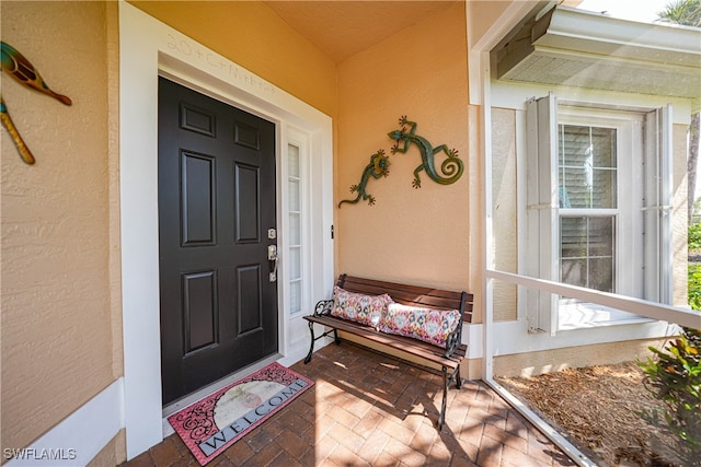 doorway to property featuring covered porch