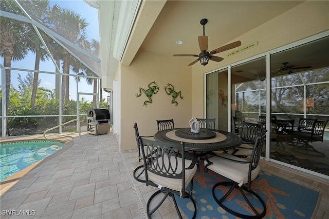 view of patio with ceiling fan, a grill, and a lanai