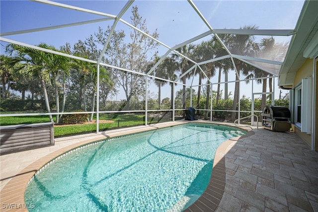 view of swimming pool featuring a patio, area for grilling, and glass enclosure