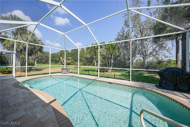 view of swimming pool with a lanai, area for grilling, a patio, and a yard