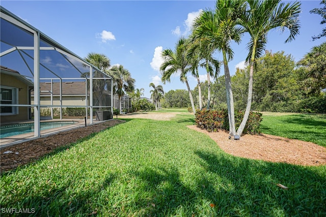 view of yard with glass enclosure