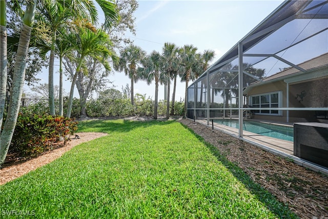 view of yard with glass enclosure