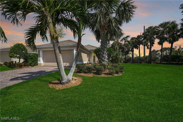 view of front facade featuring a lawn and a garage