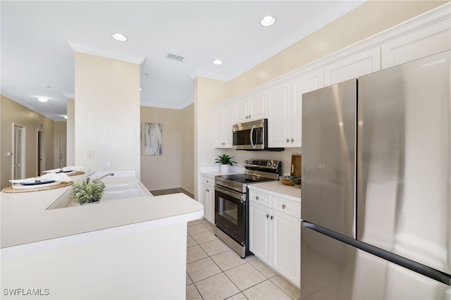 kitchen featuring visible vents, light tile patterned floors, appliances with stainless steel finishes, white cabinetry, and a sink