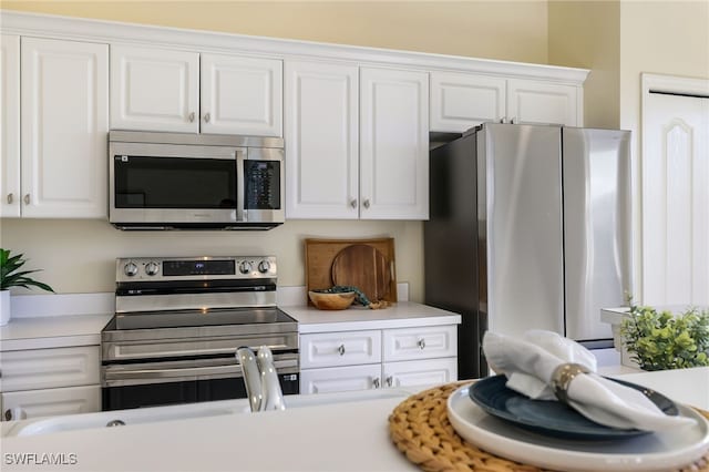 kitchen featuring white cabinetry, light countertops, and appliances with stainless steel finishes