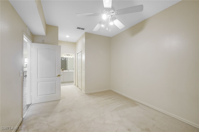 empty room with visible vents, baseboards, light colored carpet, and a ceiling fan