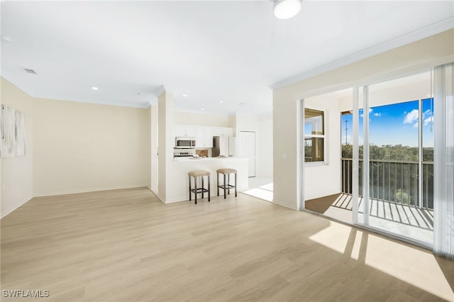 unfurnished living room featuring light wood finished floors, recessed lighting, crown molding, and baseboards