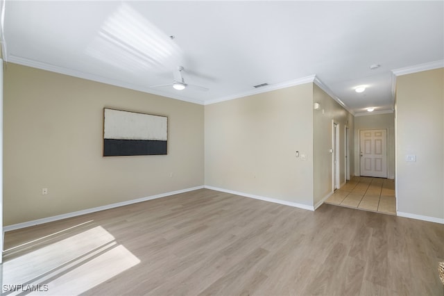 unfurnished room featuring visible vents, baseboards, ceiling fan, ornamental molding, and light wood-style flooring