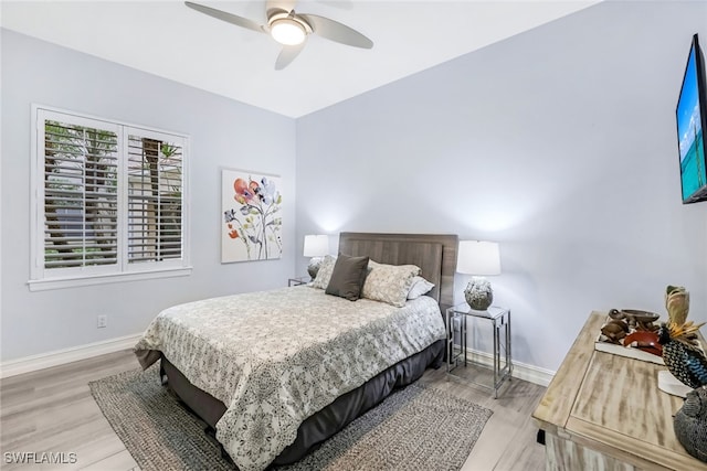 bedroom with ceiling fan and light hardwood / wood-style floors