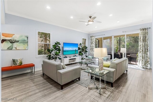 living room with ceiling fan, ornamental molding, and light wood-type flooring