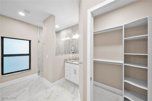 bathroom featuring vanity and an enclosed shower